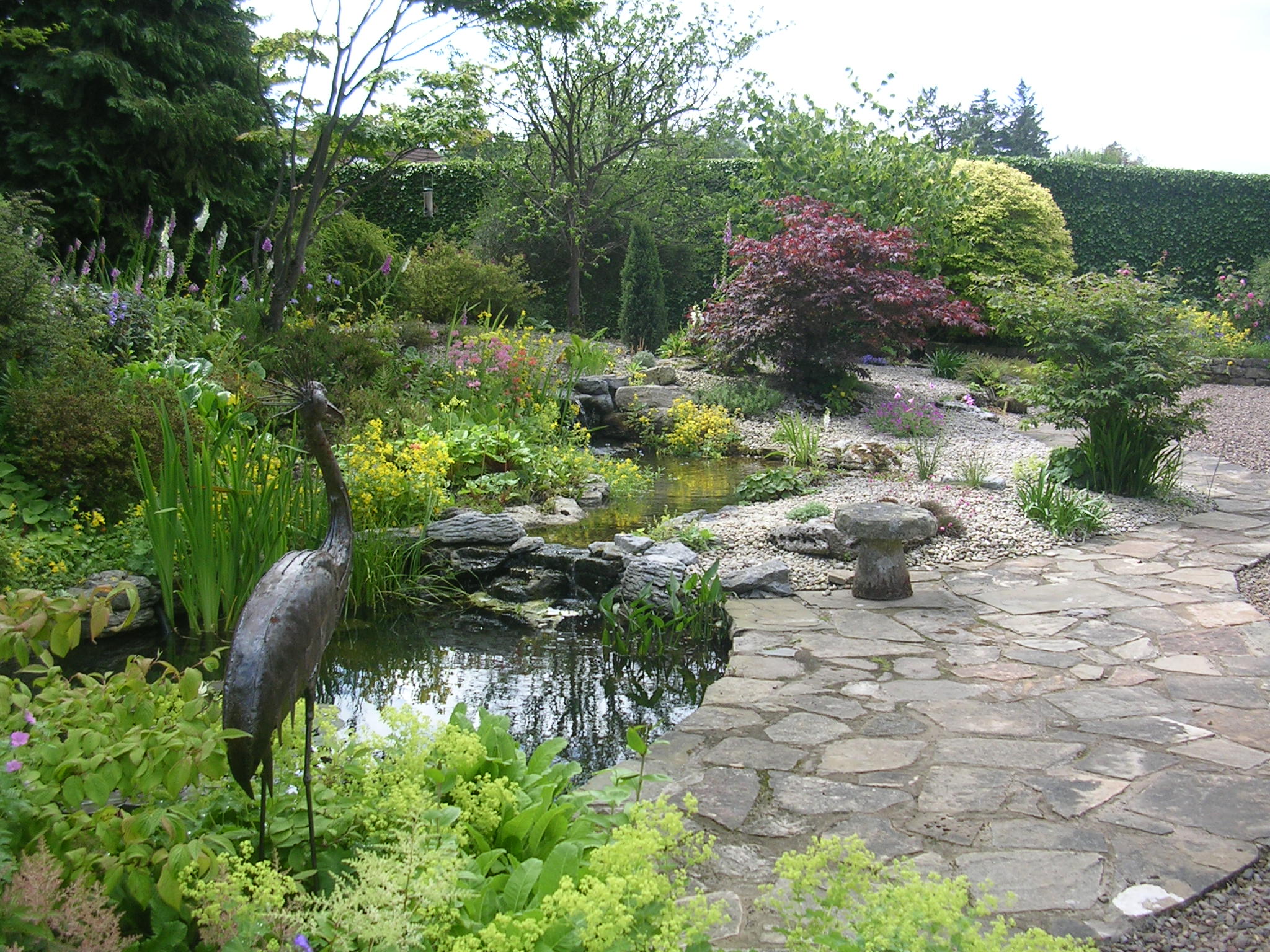 Limestone pond with a large meandering stream - Almond Landscapes